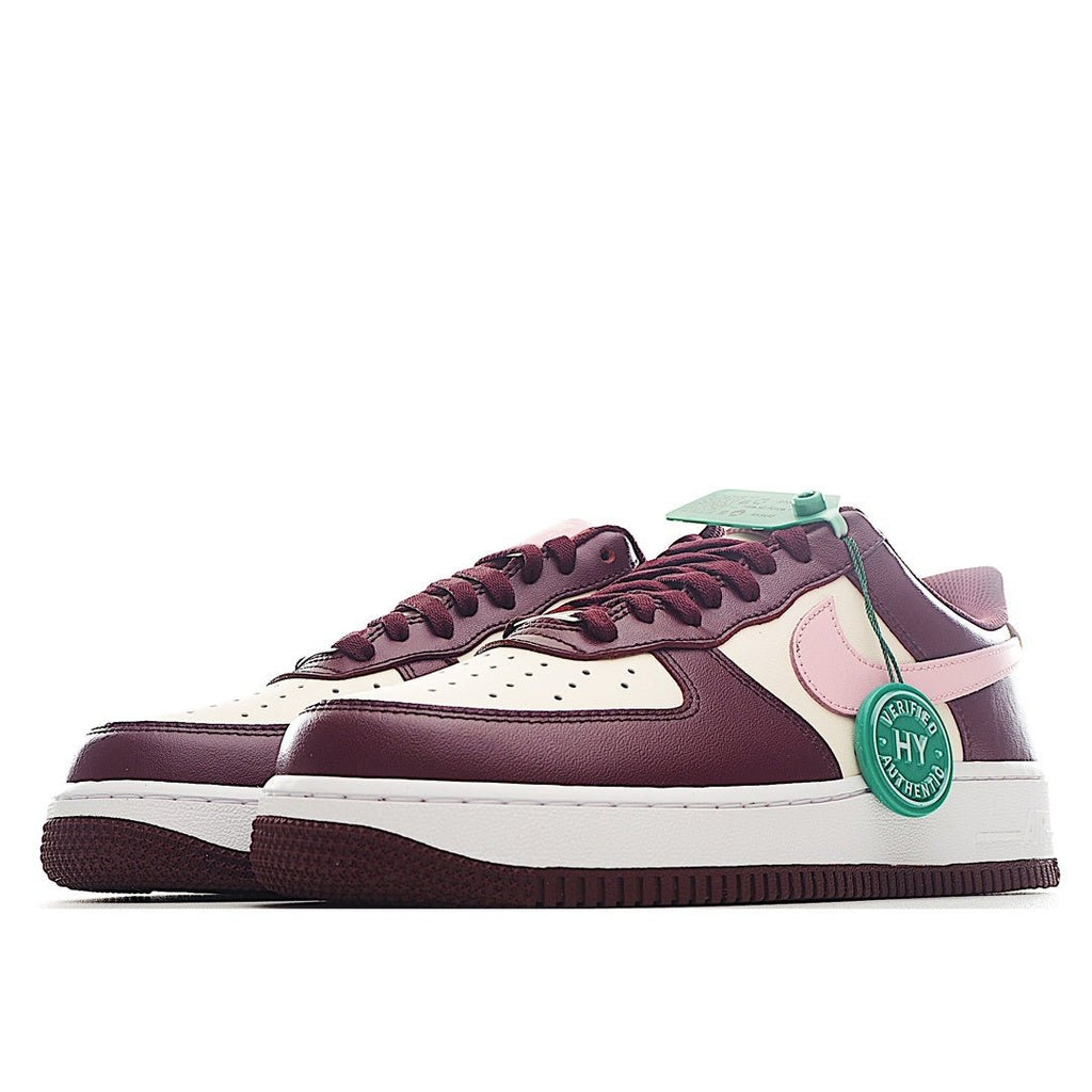 Nike Air Force 1 low-top sneaker pair in burgundy and white with pink panel and green tag
