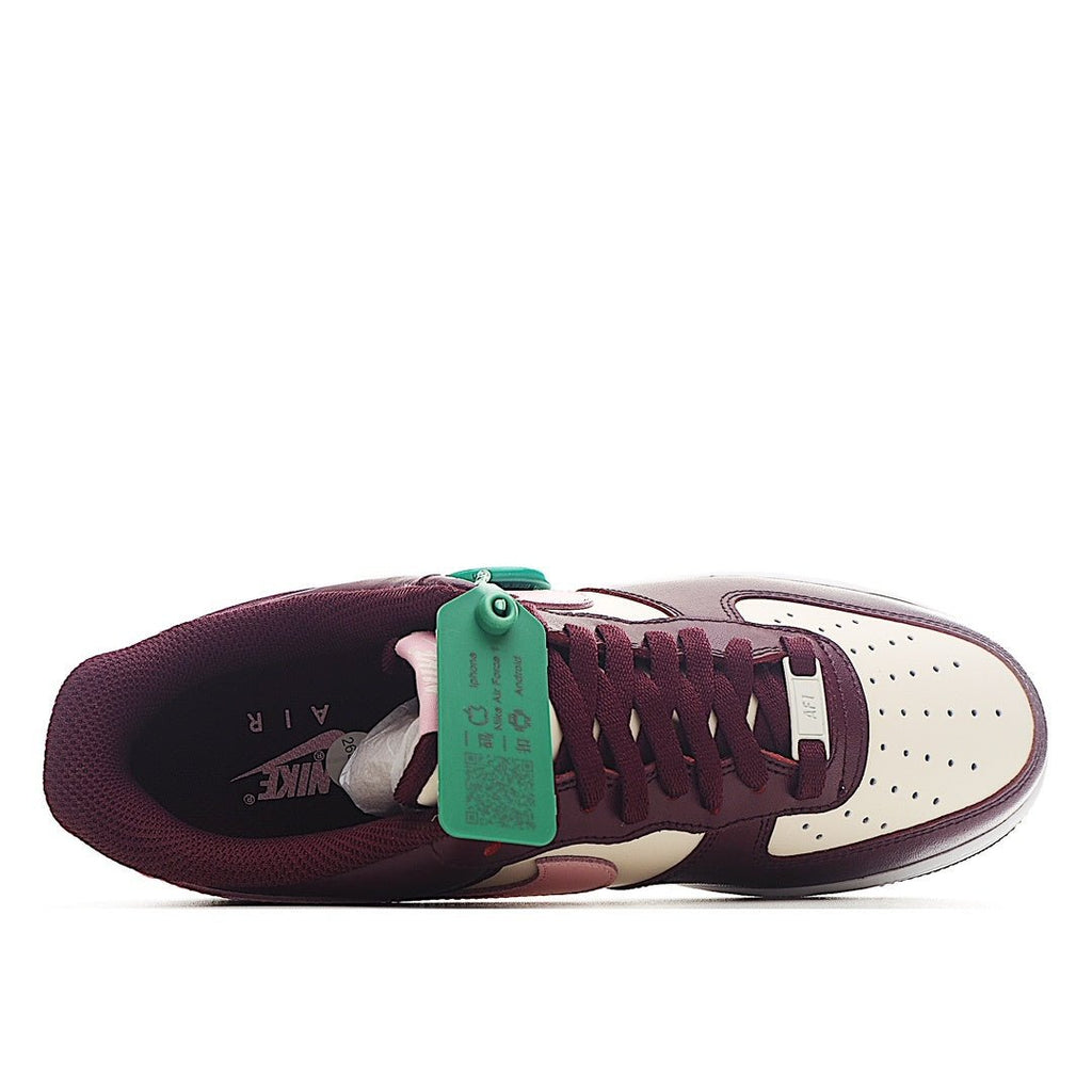Nike Air Force 1 sneaker close-up, burgundy and white with green HY tag at tongue