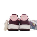 Nike Air Force 1 sneaker heel view in burgundy with white midsole and pink tongue lining