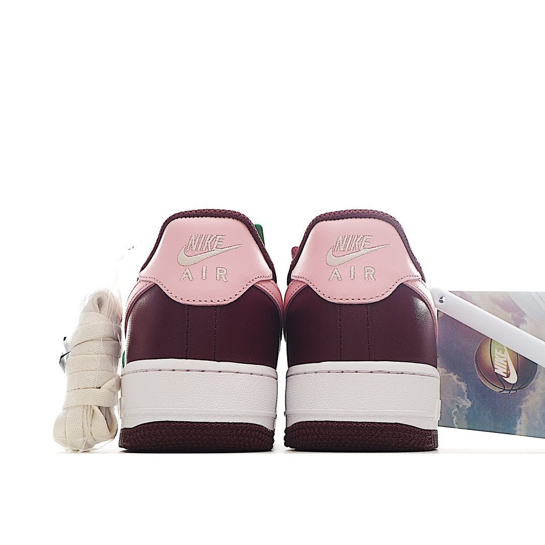 Nike Air Force 1 sneaker heel view in burgundy with white midsole and pink tongue lining