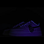 Nike Air Force 1 sneaker in dark purple with blue accents and HY tag at side