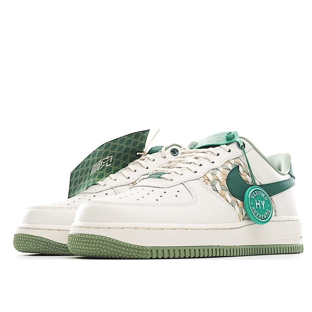 Low-top sneakers with white leather upper and dark green accents, green outsole