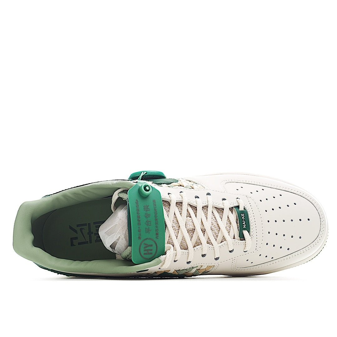 White and green low-top sneakers, heel view with laces and green collar padding.