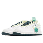 White Nike Air Force 1 sneakers with light green lining, teal accents, and navy laces