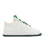 White Nike Air Force 1 low-top with navy lace eyelets and light green collar tab