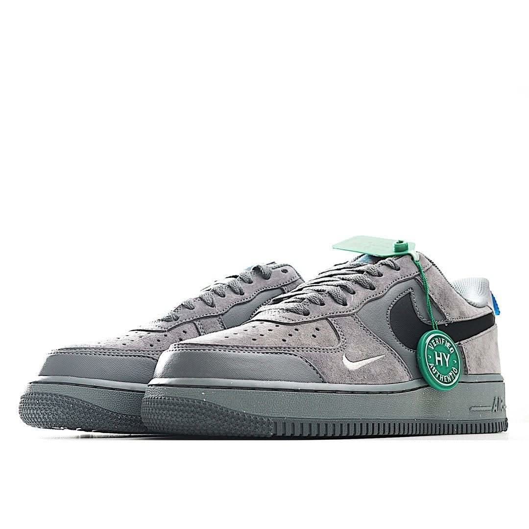 Gray Nike Air Force 1 sneakers with green heel patch and black side panel