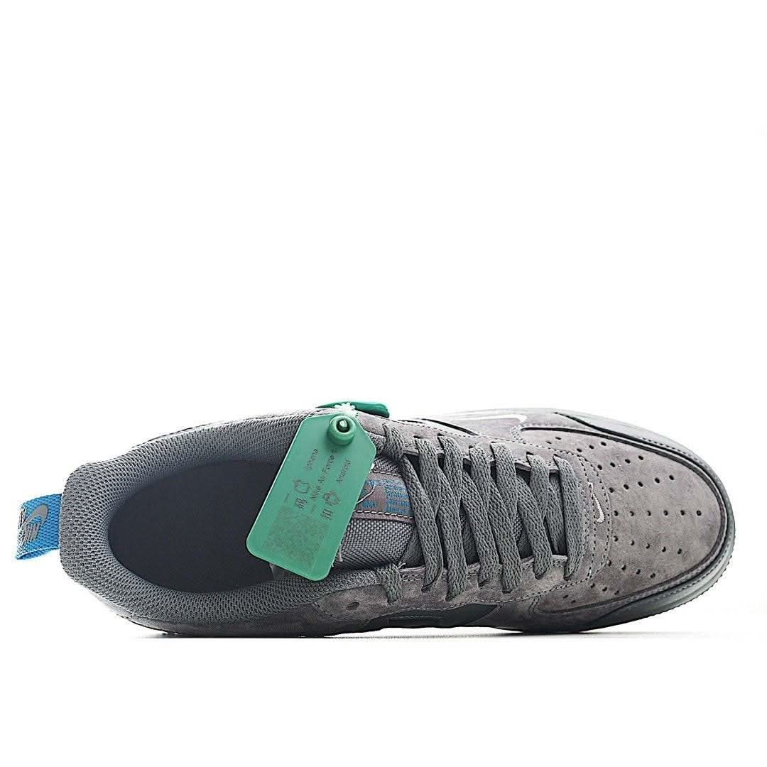 Gray Nike Air Force 1 sneakers with lace-up front and green hangtag