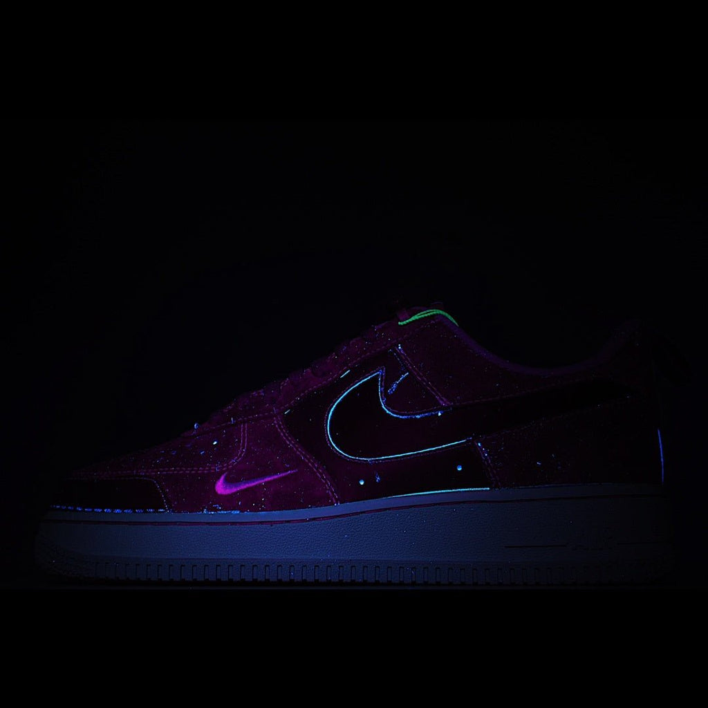 Dark purple low-top sneaker with neon blue swoosh and glow accents