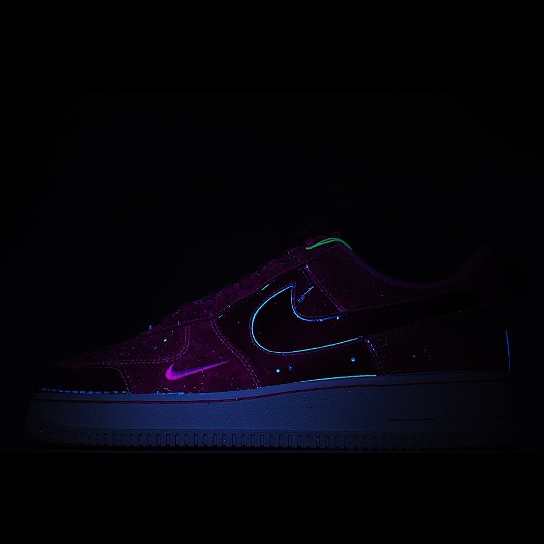 Dark purple low-top sneaker with neon blue swoosh and glow accents