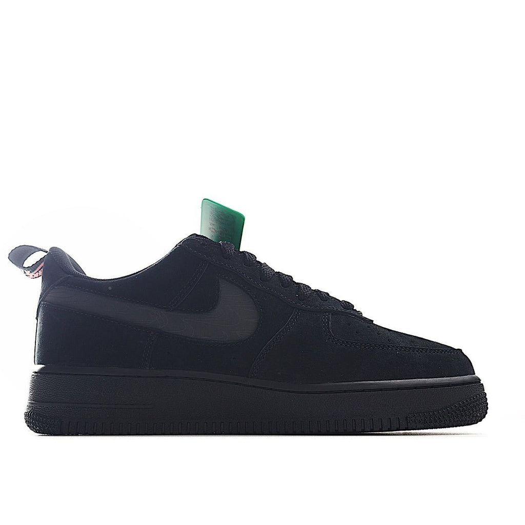 Black low-top sneaker with red swoosh, dark panels, and green tag on tongue