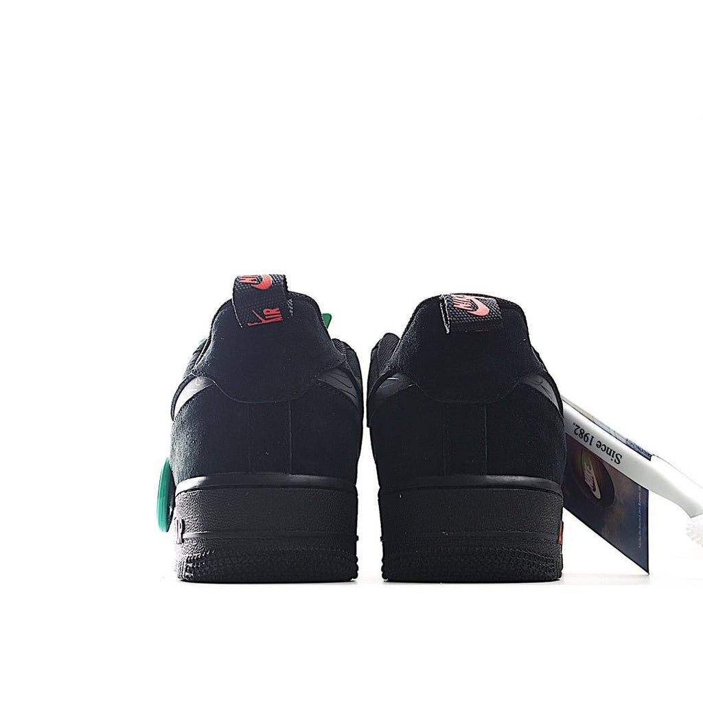 Black low-top sneaker heel view with red swoosh and teal accents