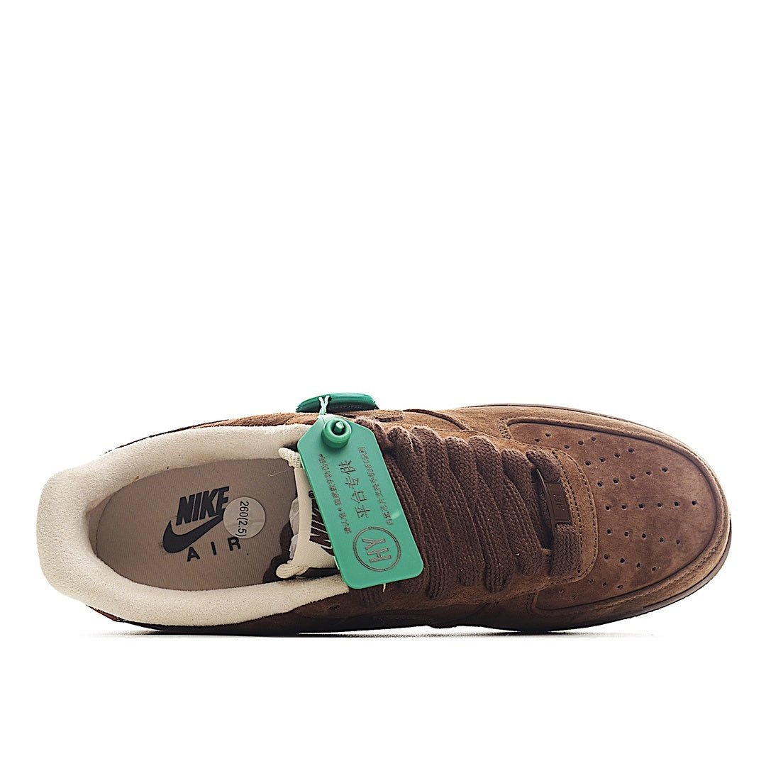 Brown suede sneaker heel and interior lining, green tag attached to the collar