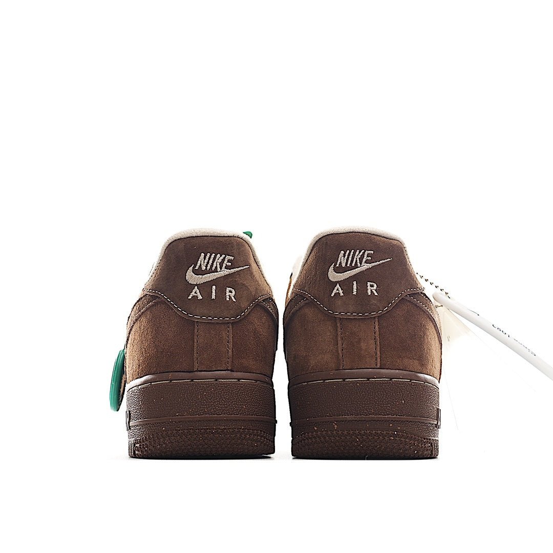 Brown suede sneaker pair, rear view with white soles and green accents on tag