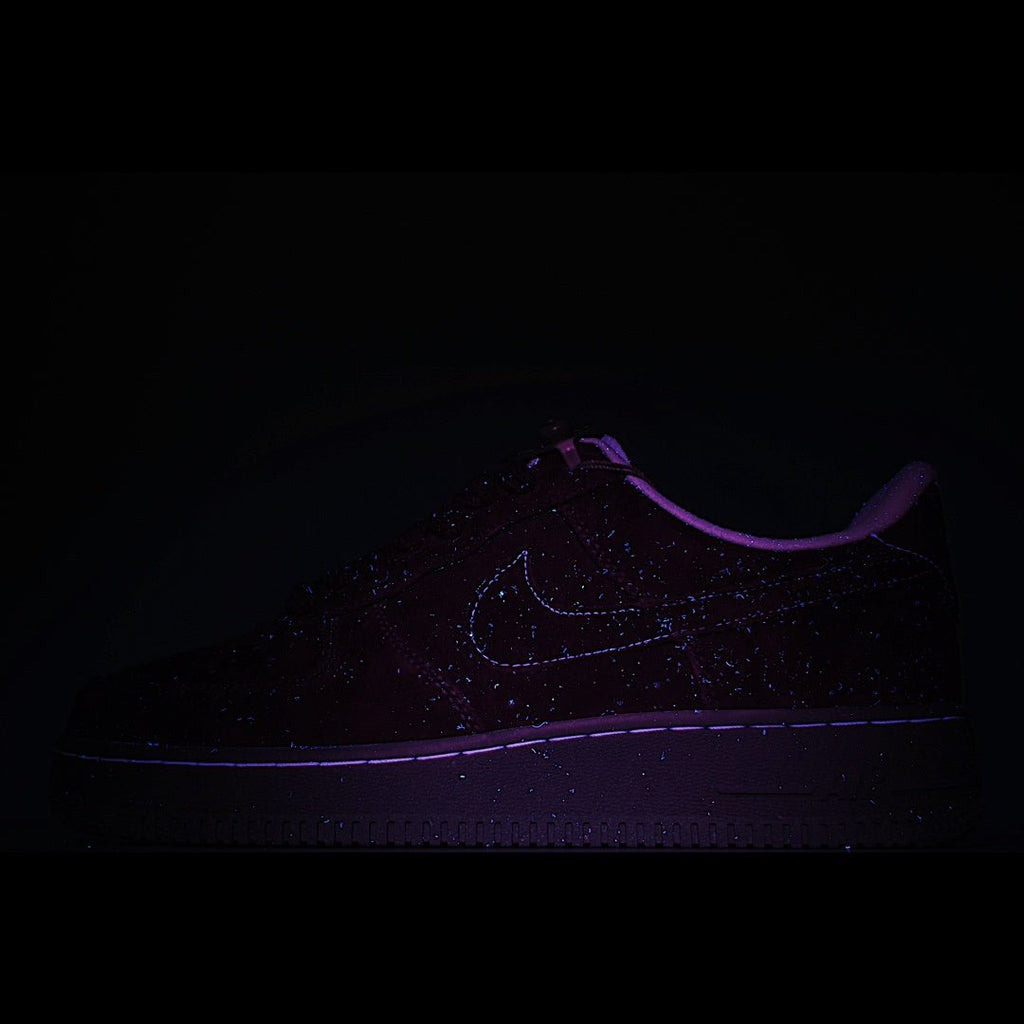 Dark sneaker with faint swoosh logo and glow-like purple outline