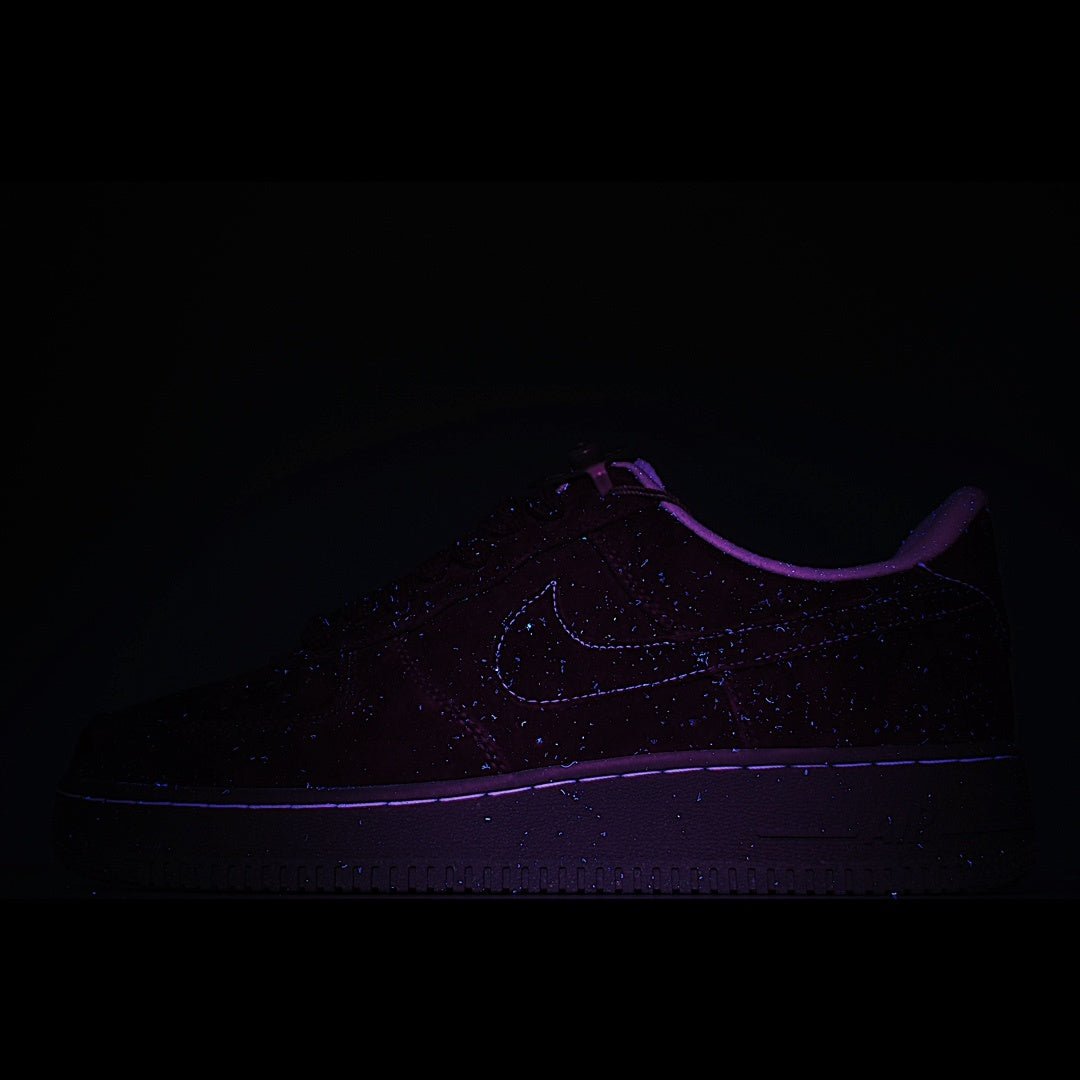 Dark sneaker with faint swoosh logo and glow-like purple outline
