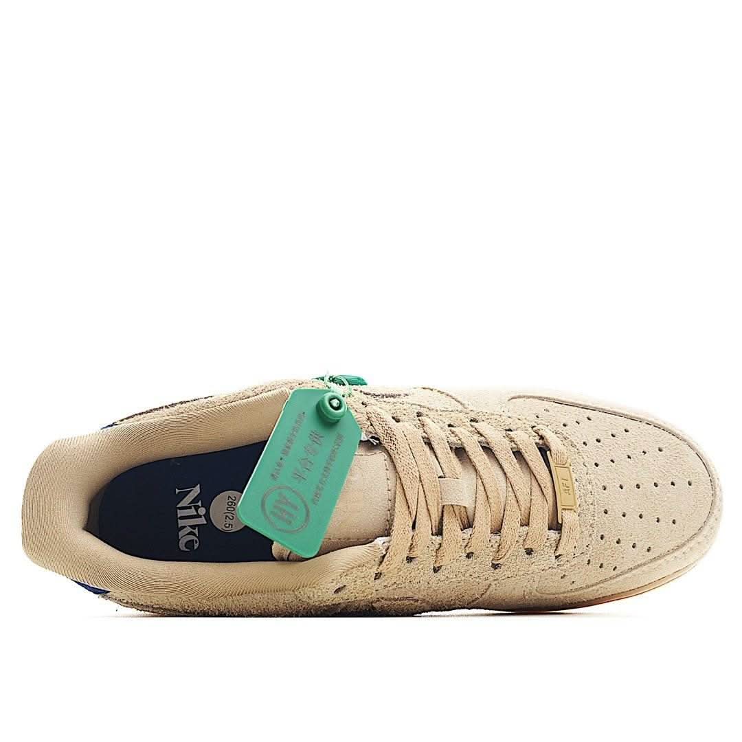 Beige suede low-top sneakers with blue interior lining, lace-up, green hang tag