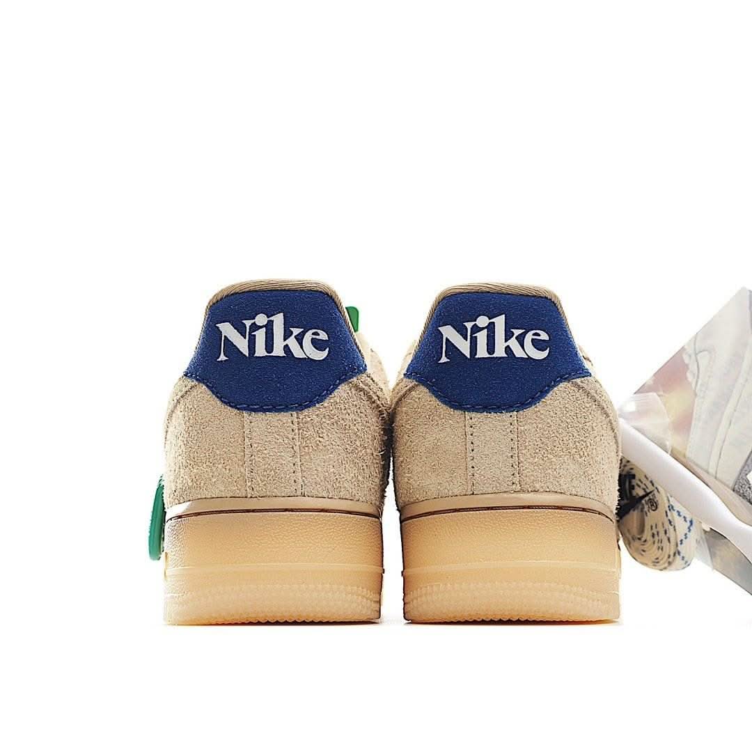Beige suede sneakers with blue Nike heel tabs and gum sole, green hang tag