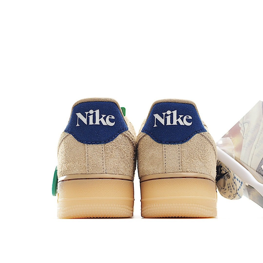 Nike Air Force 1 sneakers heel view in light beige suede with blue back panels and green tab