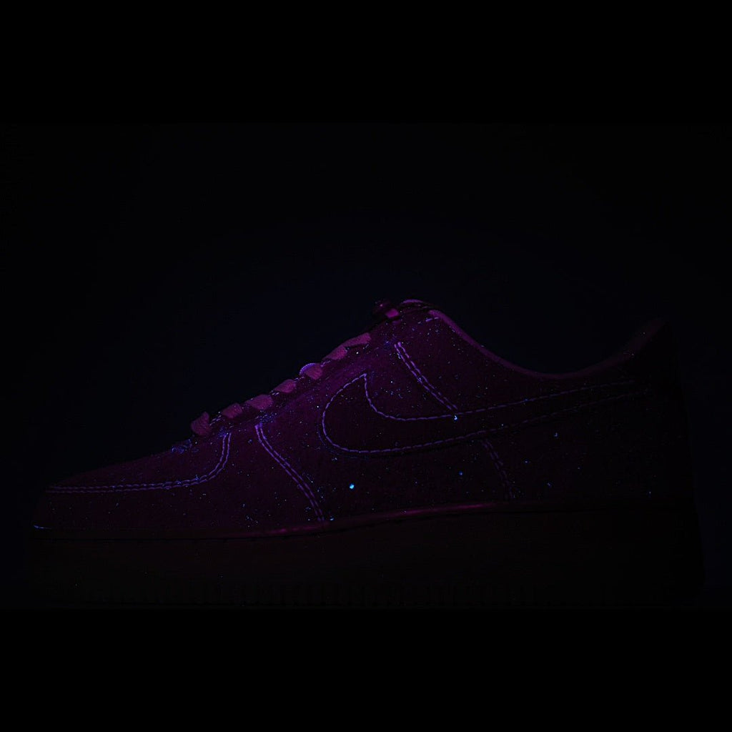 Dark purple Nike sneakers with curved swoosh and lace-up front
