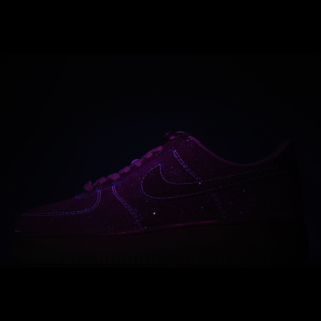 Dark purple Nike sneakers with curved swoosh and lace-up front