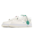 Nike Air Force 1 sneaker side view, white leather with mint green swoosh detail