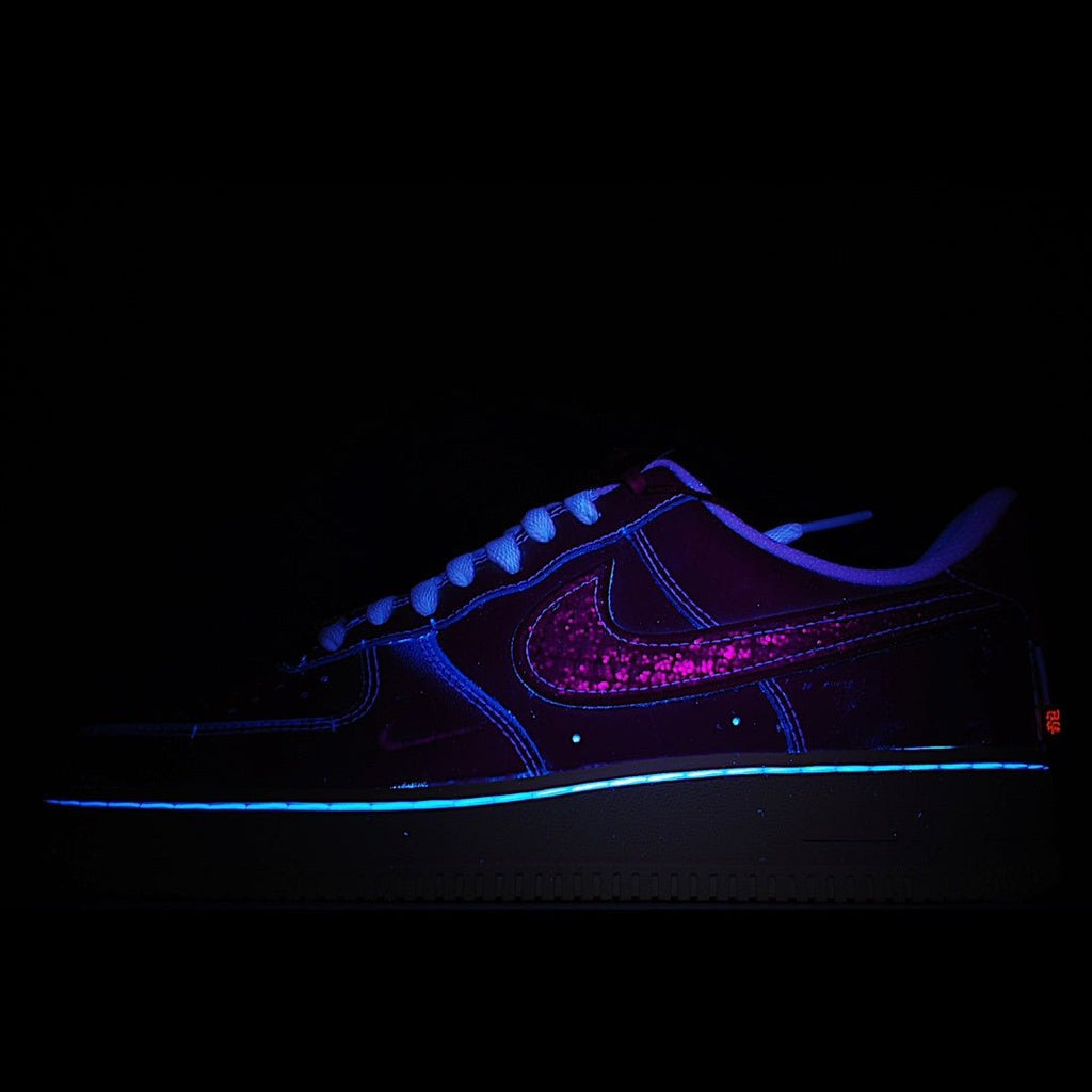 Nike Air Force 1 sneaker, dark blue upper with purple glitter swoosh