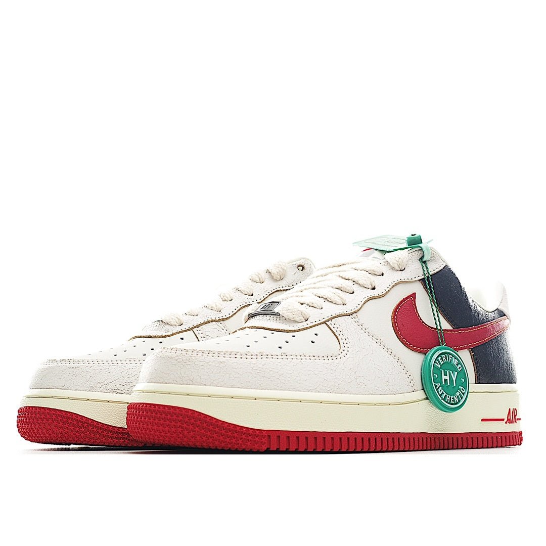 Nike Air Force 1 low sneaker, white upper with red swoosh, navy side panels, green laces