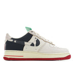 Nike Air Force 1 sneaker, white leather with dark swoosh, navy heel, green accent tab