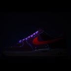 Nike Air Force 1 sneaker, dark upper with red swoosh accents