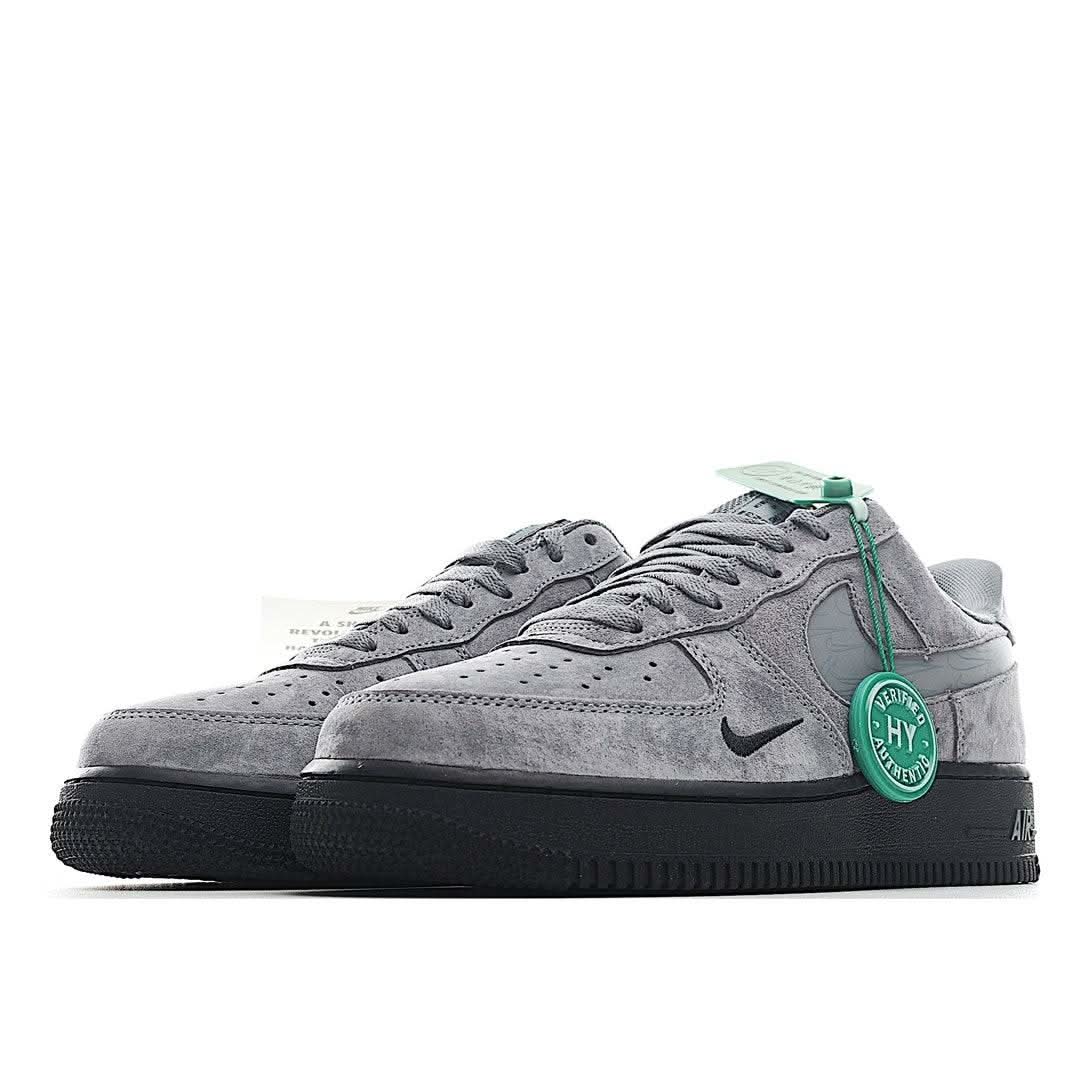 Grey suede low-top sneakers with Nike swoosh, green lace tag, and black outsole