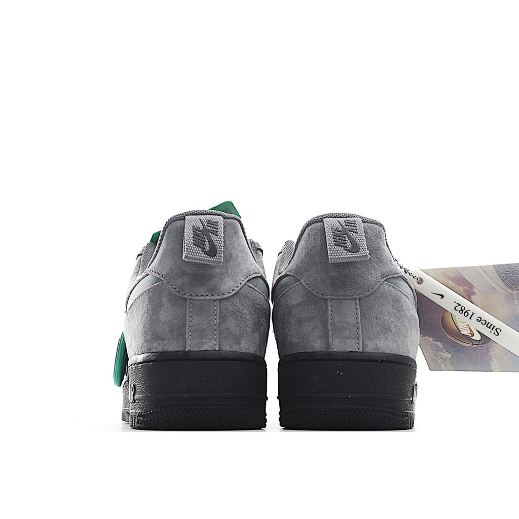 Gray suede pair from the heel, green tags on top, with black sole