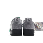 Gray suede pair from the heel, green tags on top, with black sole