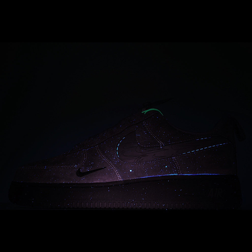 Dark gray sneakers with subtle blue-purple stitching detail