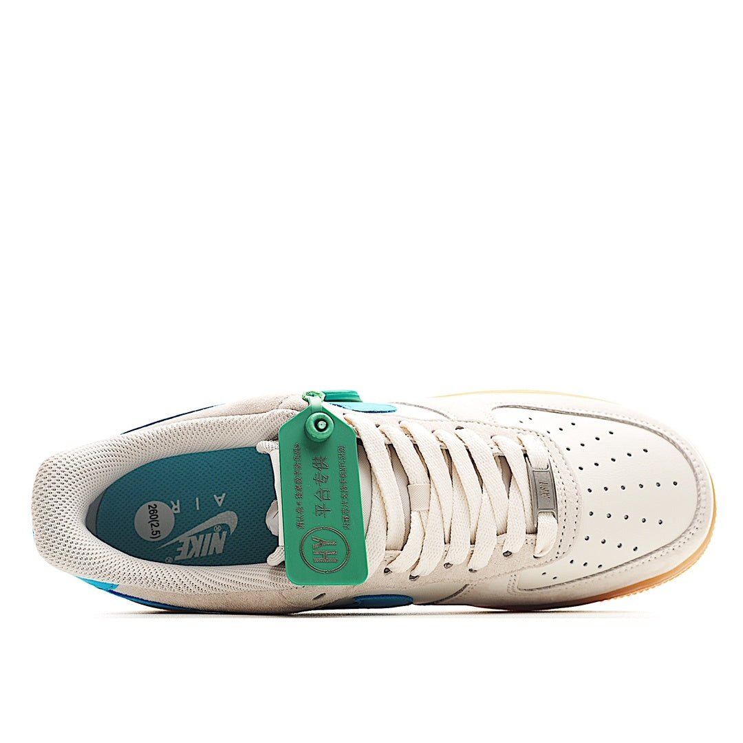 White sneaker with laces and teal-lined interior; gum sole
