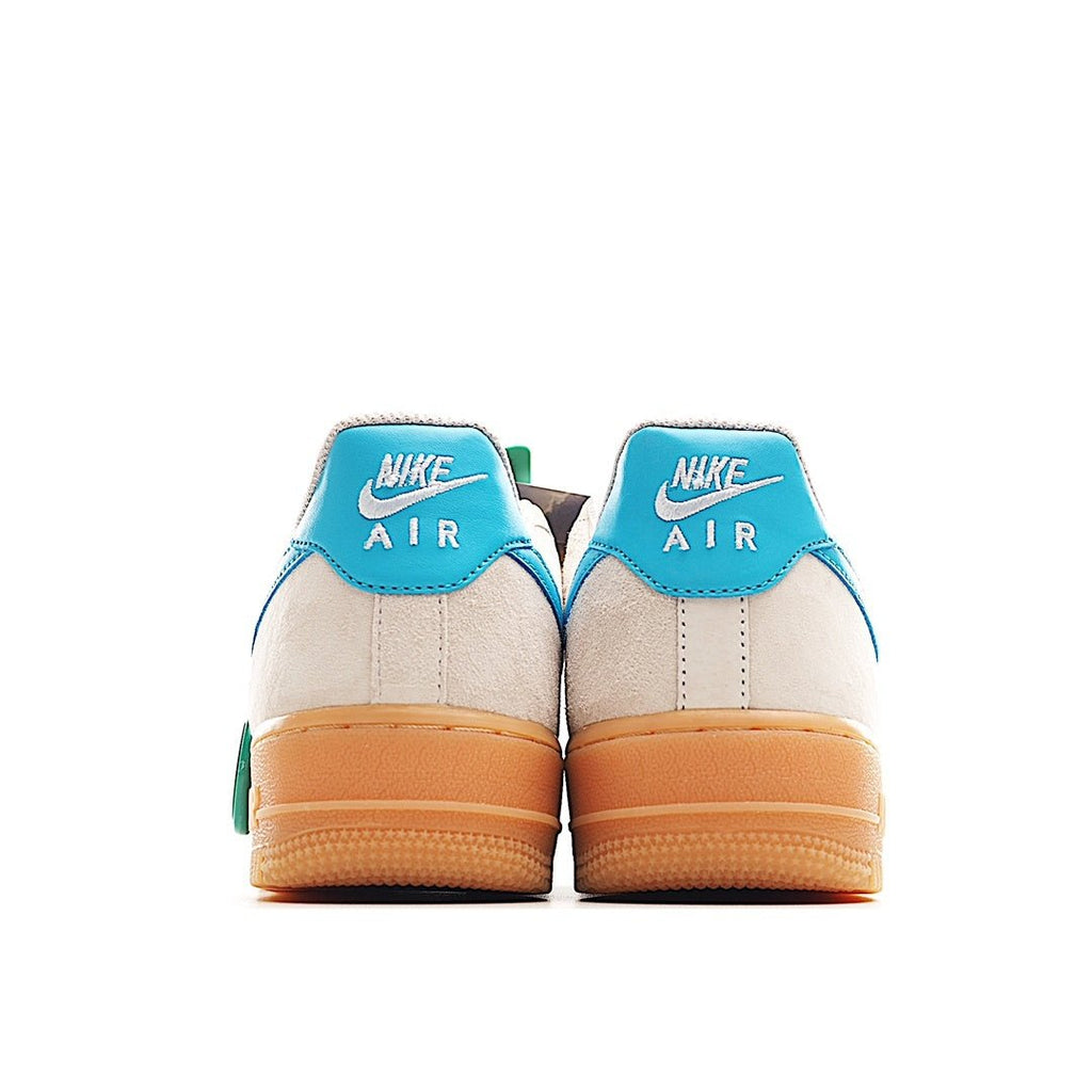 Pair of white sneakers with teal heel panels and tan gum outsoles