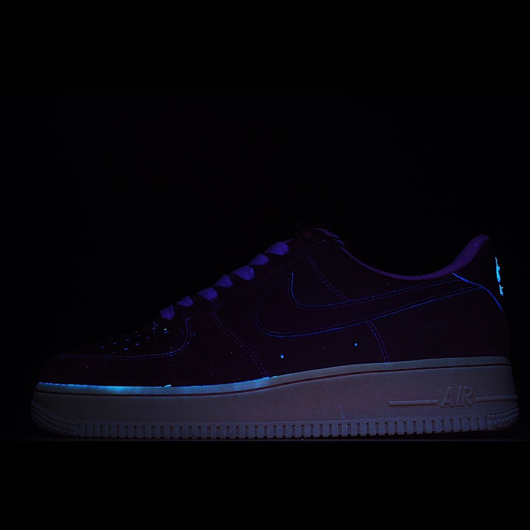 Dark blue low-top sneakers with blue swoosh and Air-cushioned sole