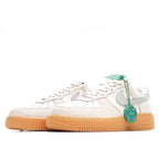 Low-top sneakers in off-white leather with gray swoosh and gum outsole; green heel tag