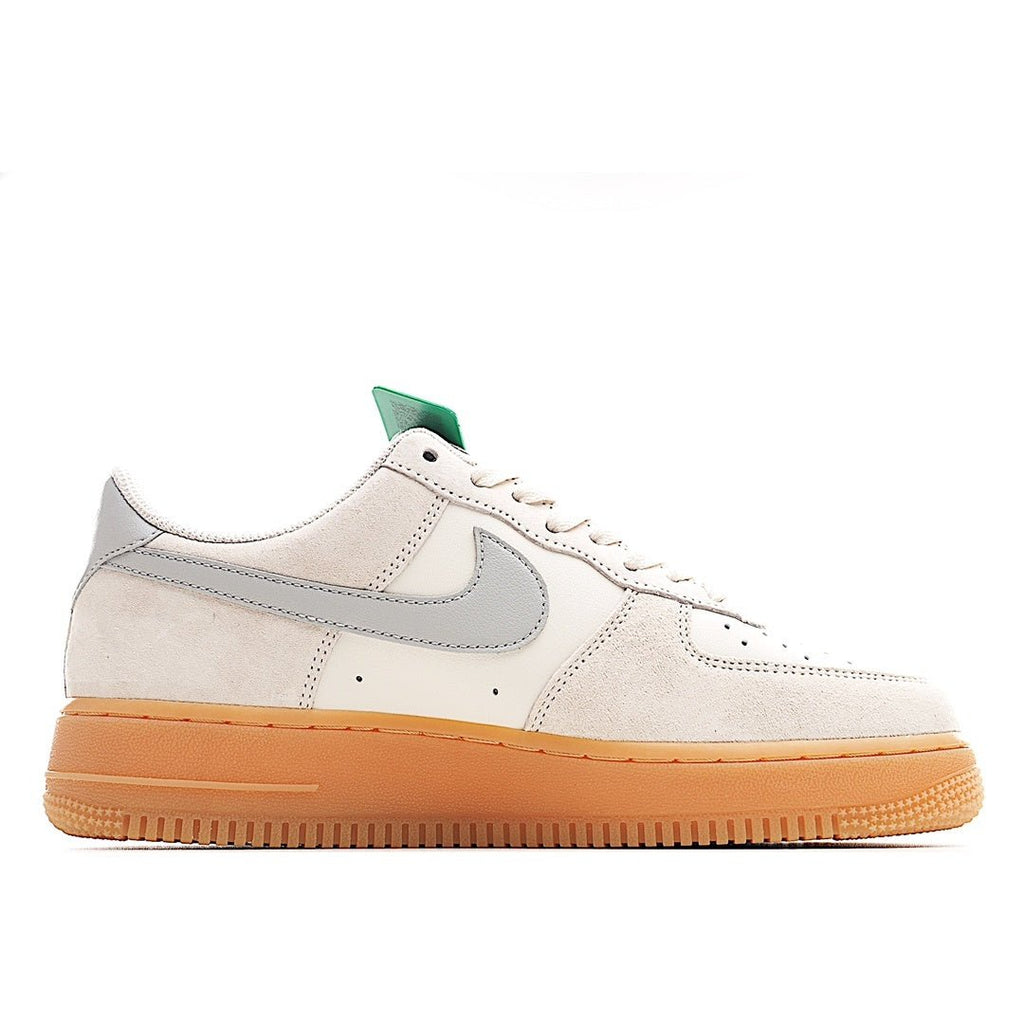 Low-top sneakers in off-white with gray swoosh and gum sole, teal lace accent