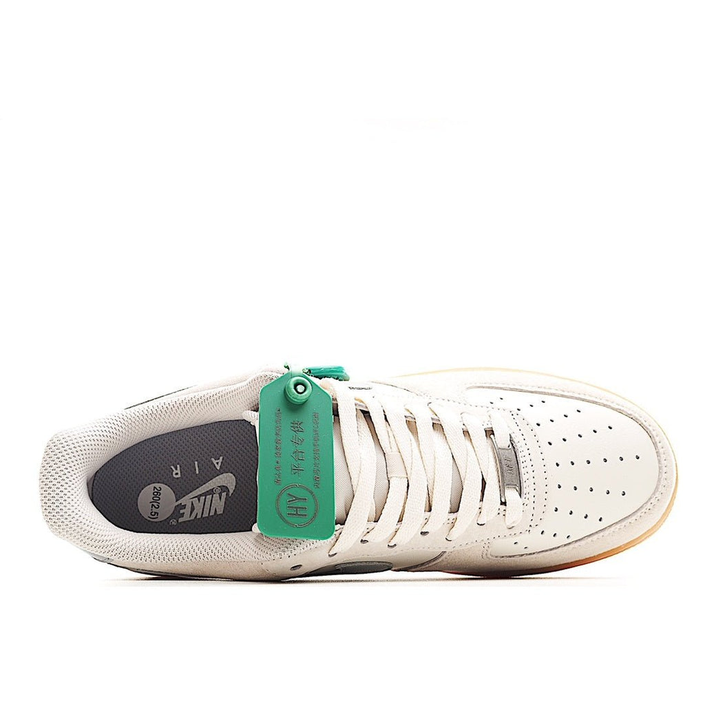 Low-top sneakers with off-white upper, teal laces tag, and gray interior collar