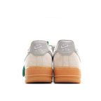 Low-top sneakers with off-white back panels, gray heel tabs, gum sole and green tag
