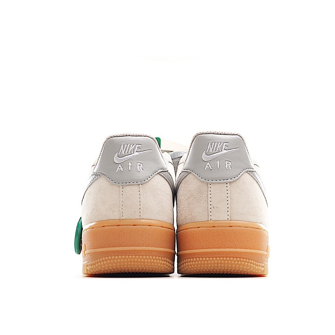 Low-top sneakers with off-white back panels, gray heel tabs, gum sole and green tag