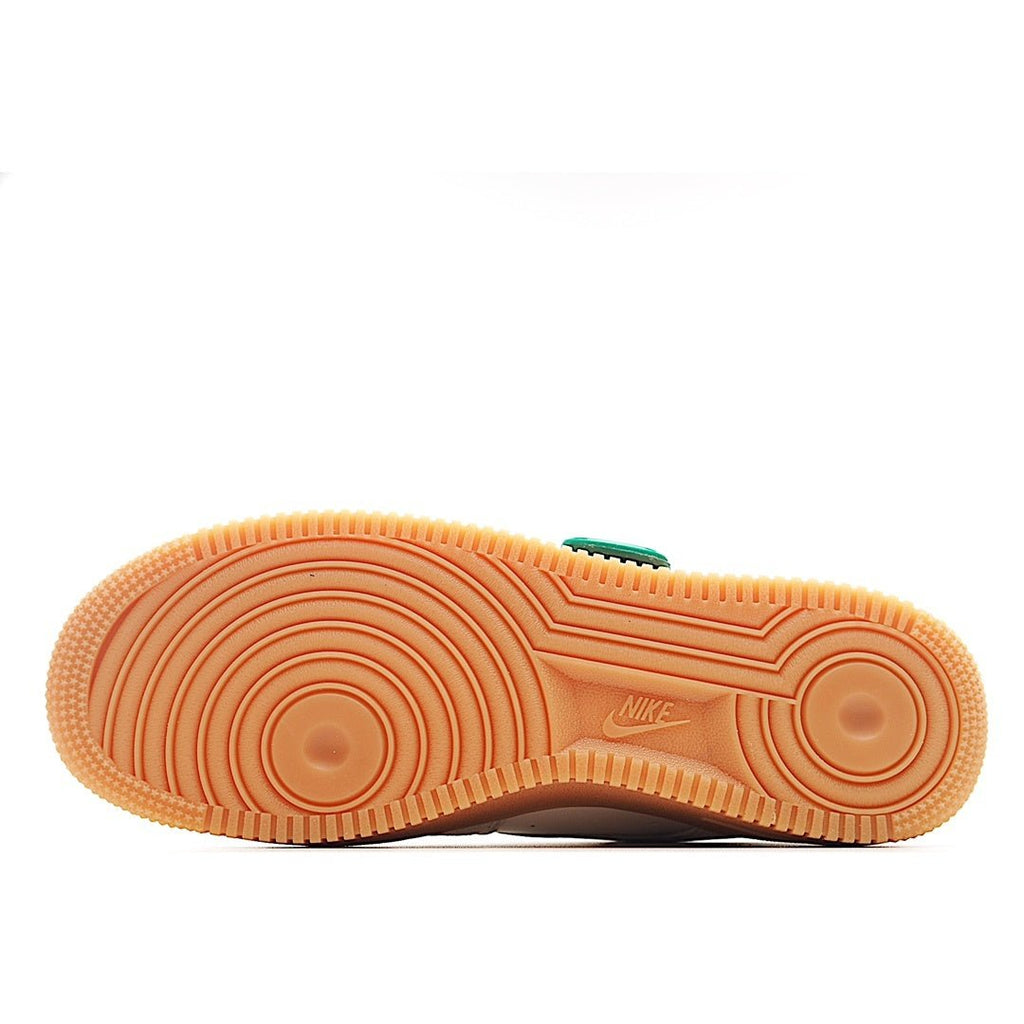 Shoe outsole tread in gum orange with small Nike mark
