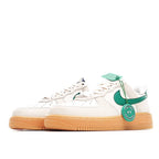 Nike Air Force 1 low-top sneakers, side view: white leather with green swoosh and tan sole