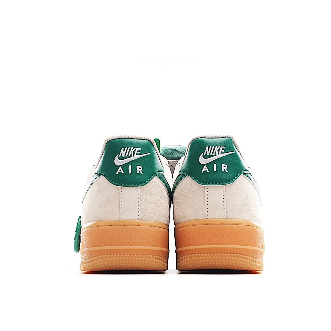 Nike Air Force 1 low-top sneakers, heel view: white upper with green heel panels and tan midsole