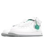 White low-top sneaker side view with gray stripe and green heel tab detail
