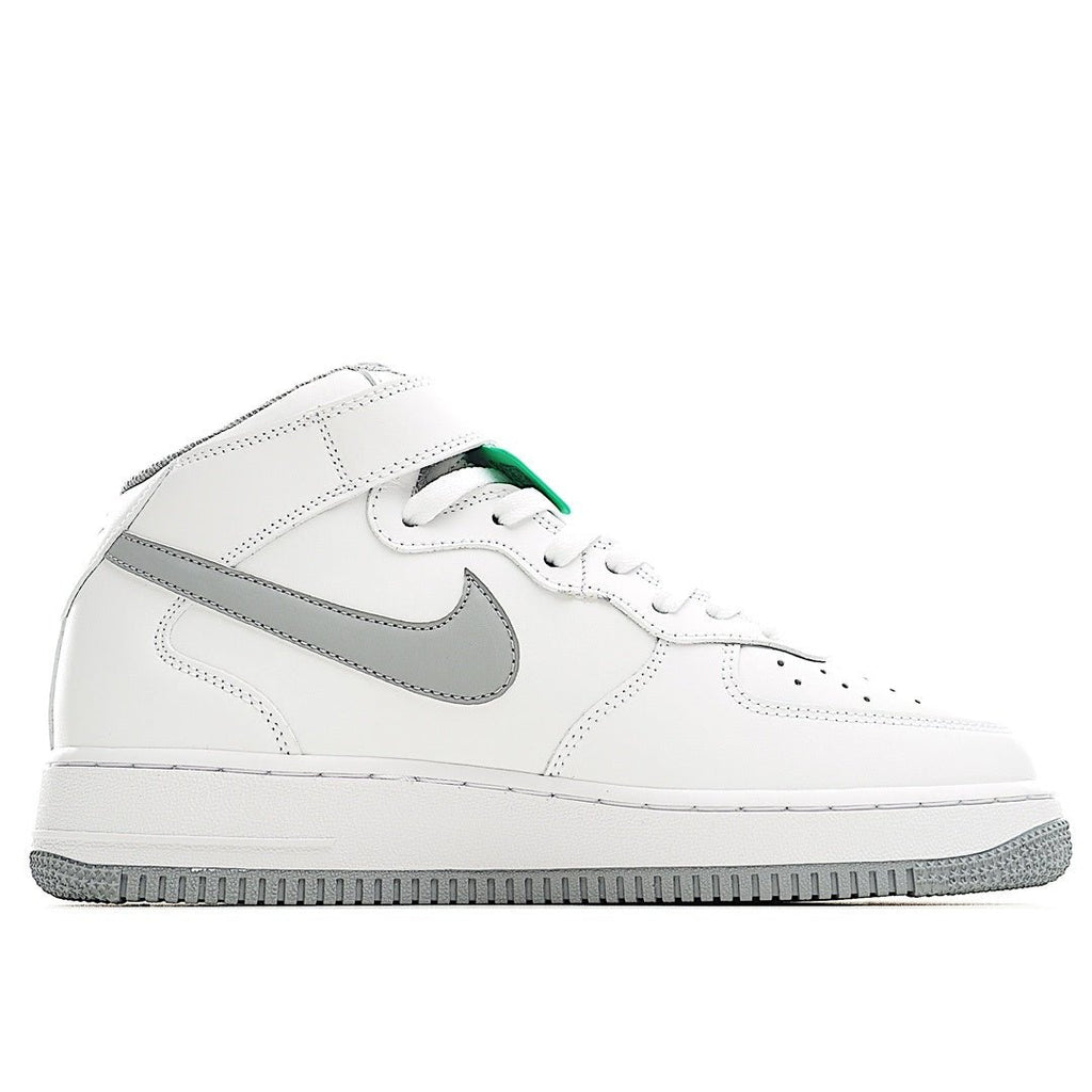 White leather sneaker with gray swoosh and green-trimmed collar accents