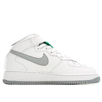White leather sneaker with gray swoosh and green-trimmed collar accents