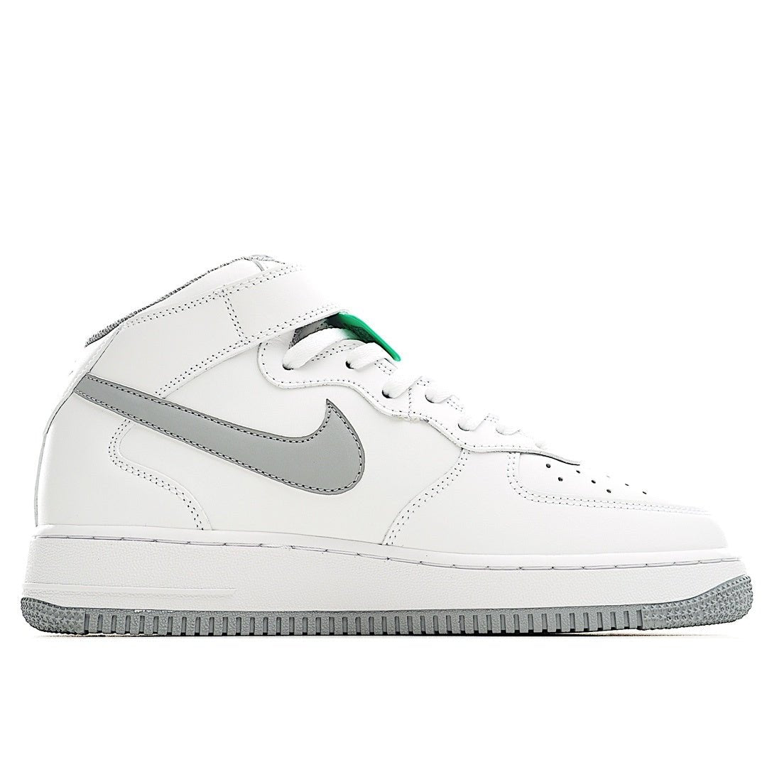 White leather sneaker with gray swoosh and green-trimmed collar accents