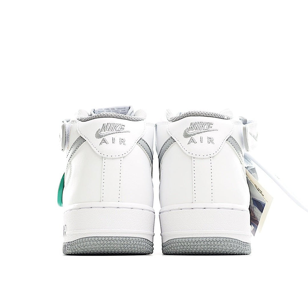 White high-top sneaker heel view with gray outsole and green accents on back