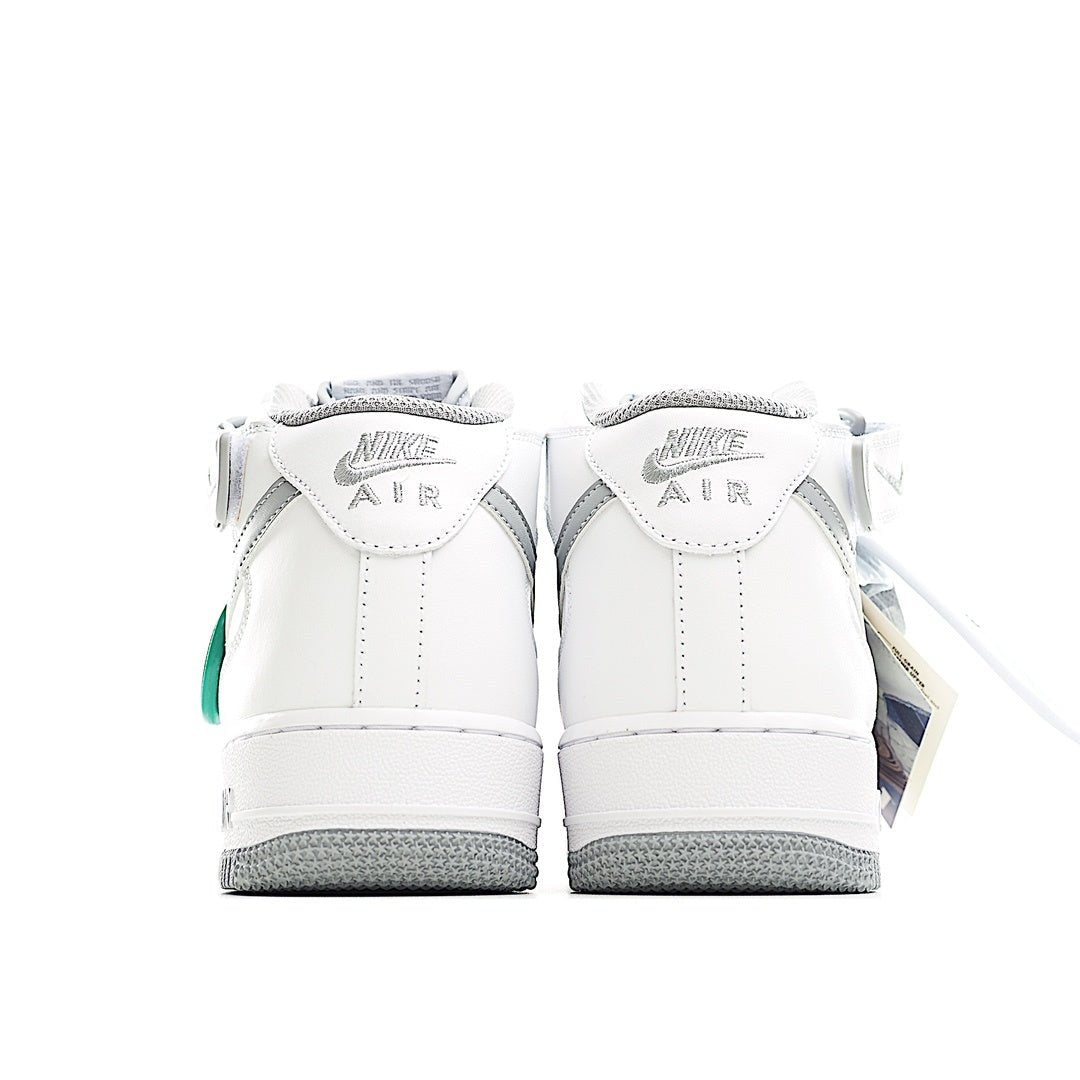 White high-top sneaker heel view with gray outsole and green accents on back